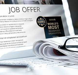 Laptop screen displaying job offer alongside company award.
