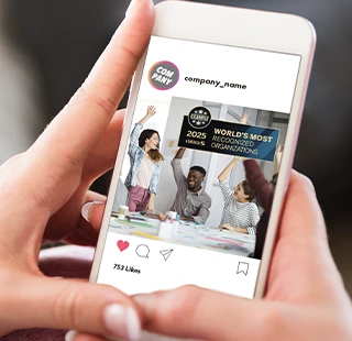 Hands holding smartphone showing company award post on social media.